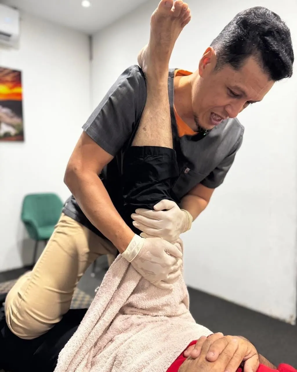 Therapist performing a targeted stretch and bone adjustment